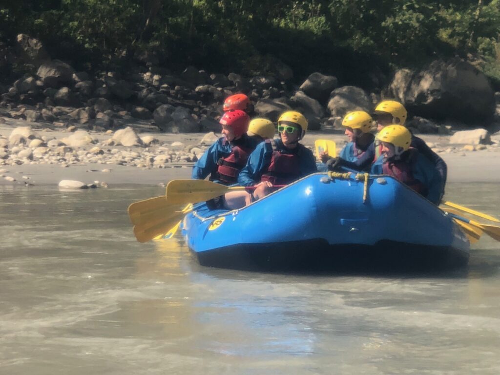 Rafting in Nepal, navigating thrilling rapids and enjoying the stunning natural scenery.