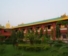 Beautiful monastery with intricate architecture in Lumbini, Nepal, surrounded by tranquil gardens.