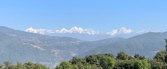 A scenic landscape capturing the panoramic mountain vistas visible from Nagarkot, showcasing the natural beauty and serenity of the Himalayan region.