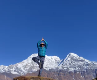 MR. Rajan doing Surya Namaskar infront of Annapurna.