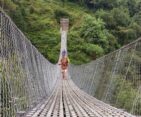 Trekkers Crossing a Suspensen Brige on the way to Mardi Himal Base Camp.