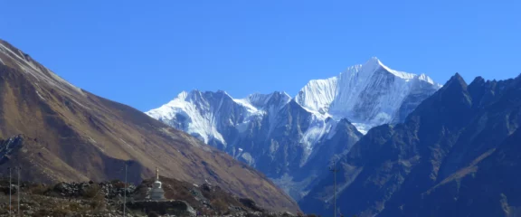 Wide-angle view of Langtang Valley surrounded by dramatic Himalayan peaks.