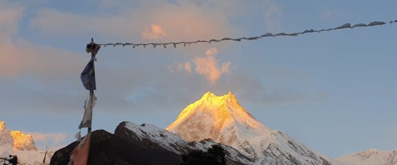 Breathtaking view of Mt. Manaslu illuminated by the golden hues of sunrise.