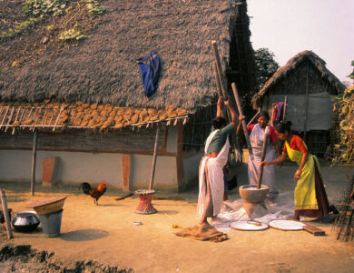 Tharu women engaged in daily work activities, reflecting the industrious and communal lifestyle of the Tharu people.