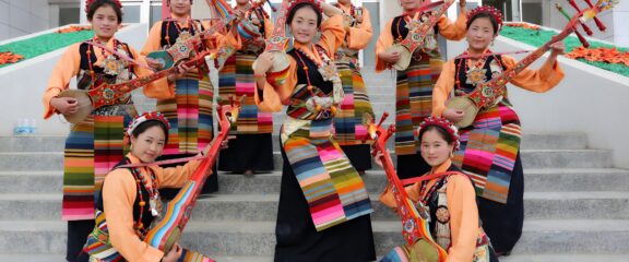 Tibetan beauty queens wearing traditional cultural dress and holding musical instruments