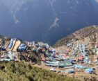 A panoramic view of Namche Bazaar from the top, showcasing the vibrant village nestled amidst the Himalayan mountains.