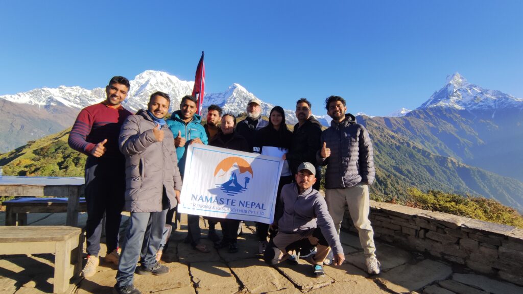 Group photo of Namaste Nepal Trekking & Research Hub team members, capturing camaraderie against a backdrop of mountain scenery.