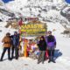 Namaste Nepal Trekking & Research Hub team at Annapurna Base Camp, celebrating the achievement with panoramic mountain views.