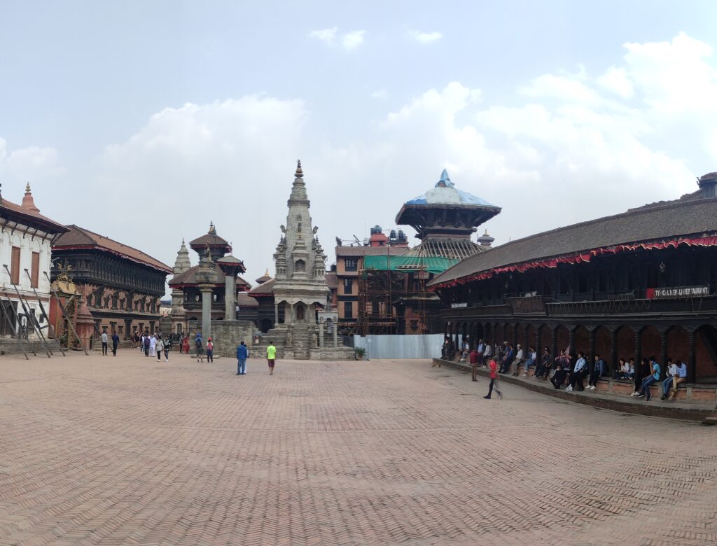 Bustling Bhaktapur Durbar Square, showcasing ancient architecture and vibrant cultural activities in Nepal.