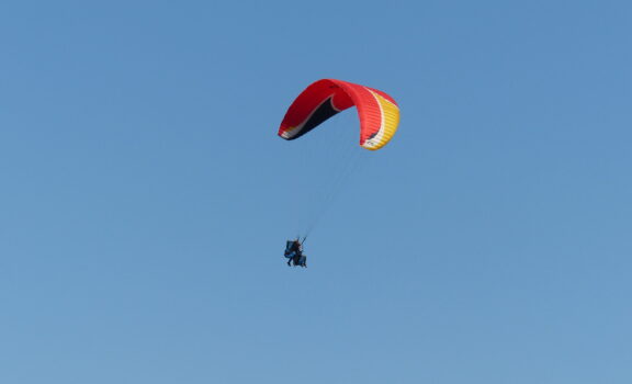 Paragliding adventure, soaring above scenic landscapes and enjoying panoramic views.