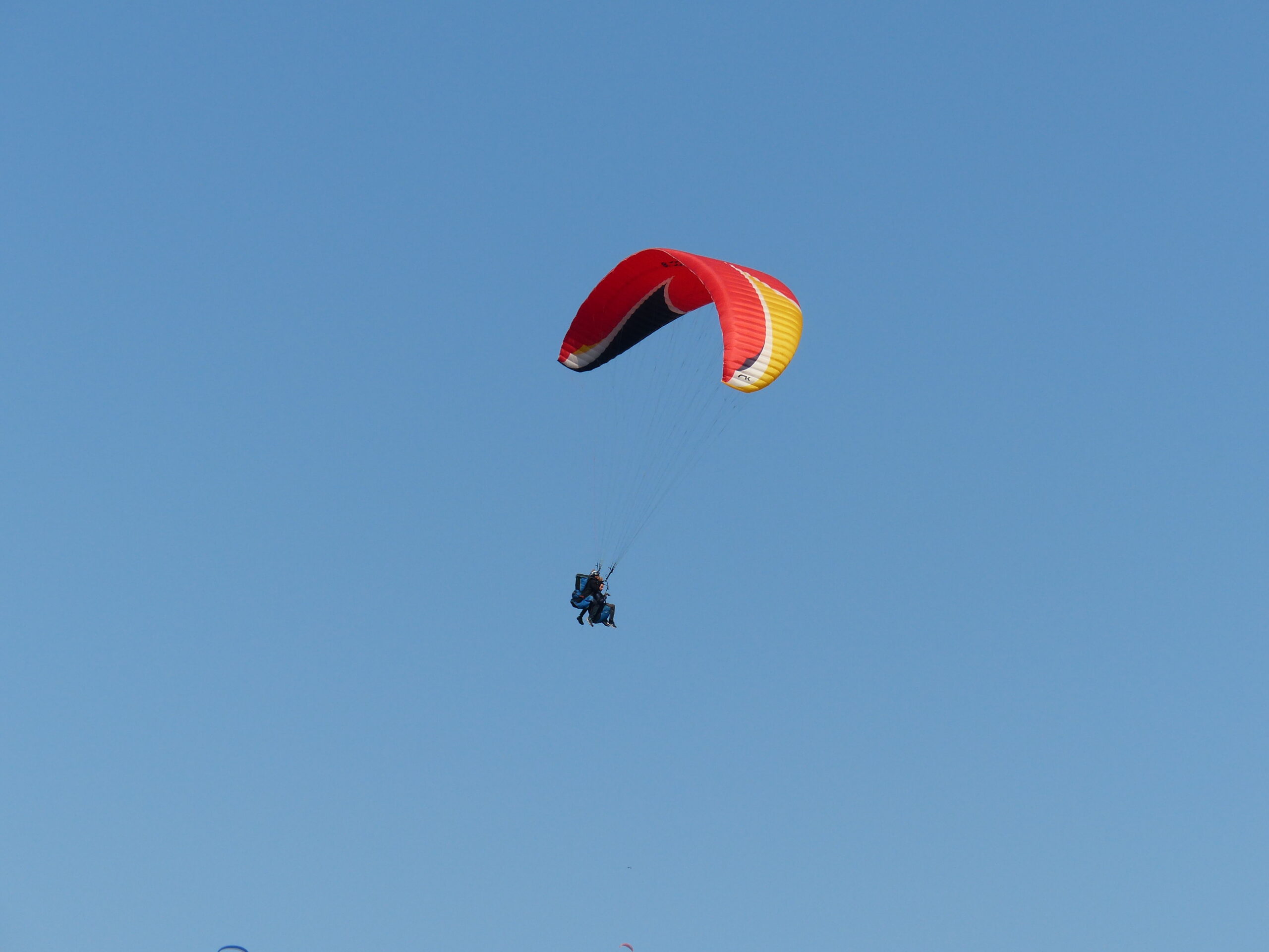 Paragliding adventure, soaring above scenic landscapes and enjoying panoramic views.