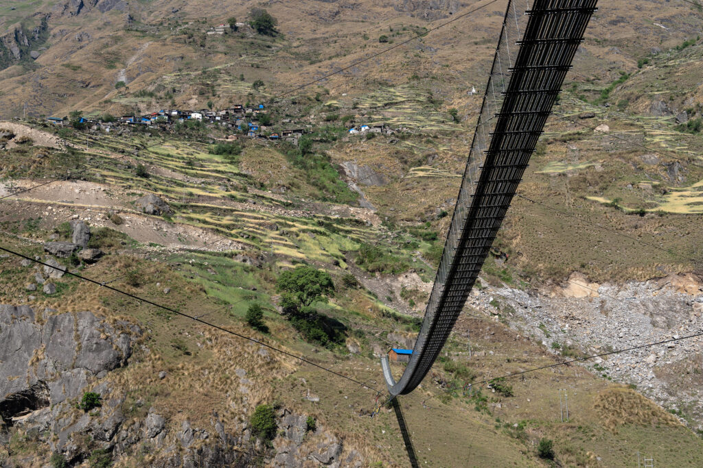 Suspension bridge along the Tsum Valley and Trek, offering breathtaking views and an adventurous crossing experience.