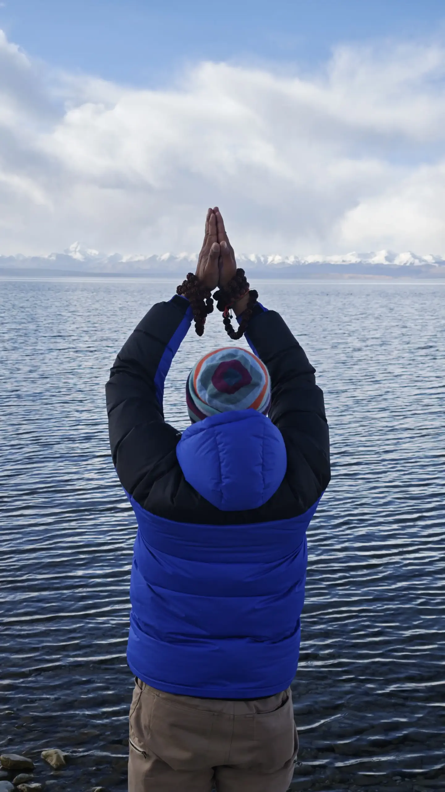 Clear waters of Lake Mansarovar and Prayer in Tibet with Mount Kailash.