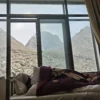 Traveler resting in their room in Derapuck with view of Mount Kailash from the window.