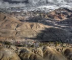 Aerial view of Lo-Manthang village, highlighting its unique architecture and surrounding mountainous terrain in Nepal's Mustang region.