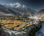 Kagbeni Village in Mustang, featuring traditional architecture and scenic landscapes amidst the rugged terrain.