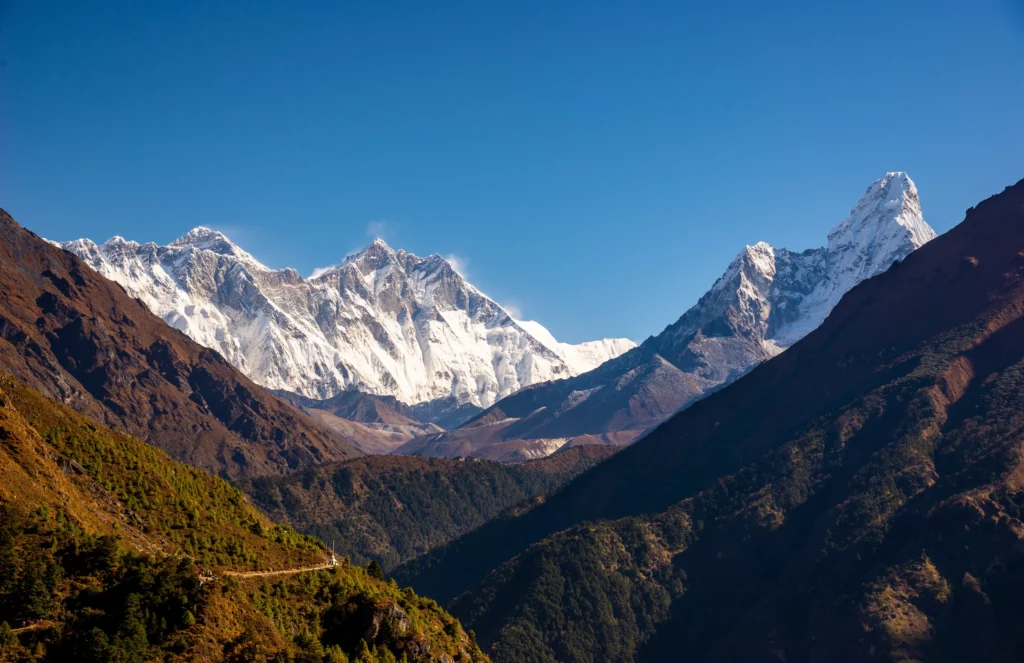 Majestic view of Everest, Lhotse, and Ama Dablam from the top of Namche Bazaar, surrounded by stunning Himalayan scenery.