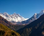 Majestic view of Everest, Lhotse, and Ama Dablam from the top of Namche Bazaar, surrounded by stunning Himalayan scenery.