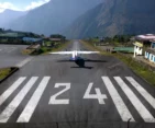 An iconic aerial view of Lukla Airport, the gateway to Everest Base Camp, nestled in the Himalayan mountains.