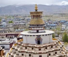 Tibetan architecture at Pelkhor Chode Monastery and Gyantse town backdrop.