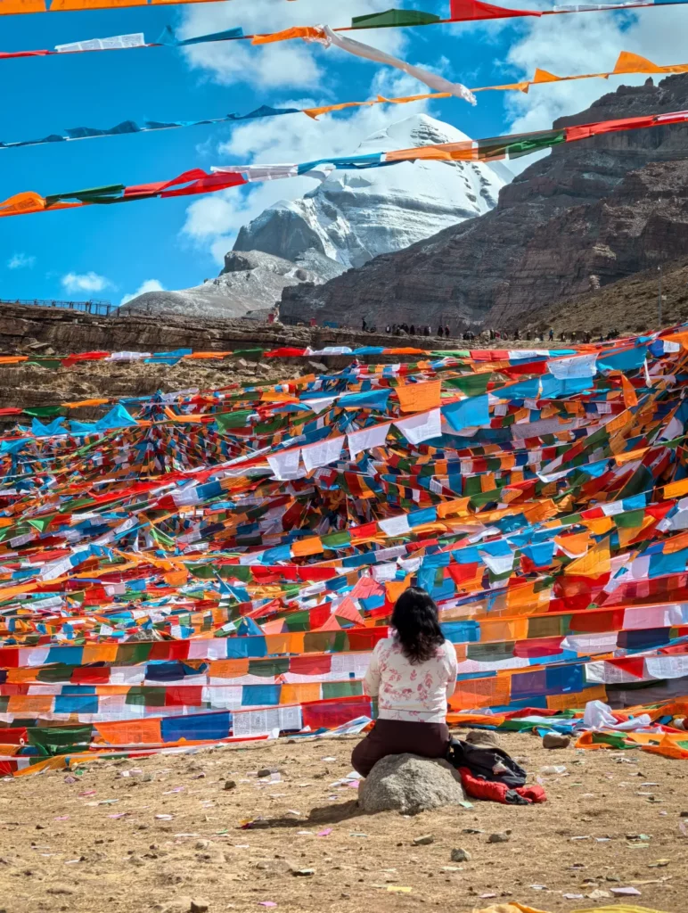 Tourists praying in front of the sacred Mount Kailash.