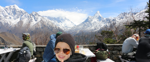 Family with young Kids enjoying breakfast with a stunning view at Everest View Hotel during the Mount Everest Helicopter Tour.