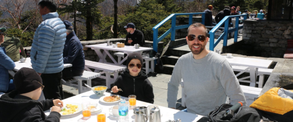Family with young Kids enjoying breakfast with a stunning view at Everest View Hotel during the Mount Everest Helicopter Tour.