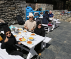 Family with young Kids enjoying breakfast with a stunning view at Everest View Hotel during the Mount Everest Helicopter Tour.