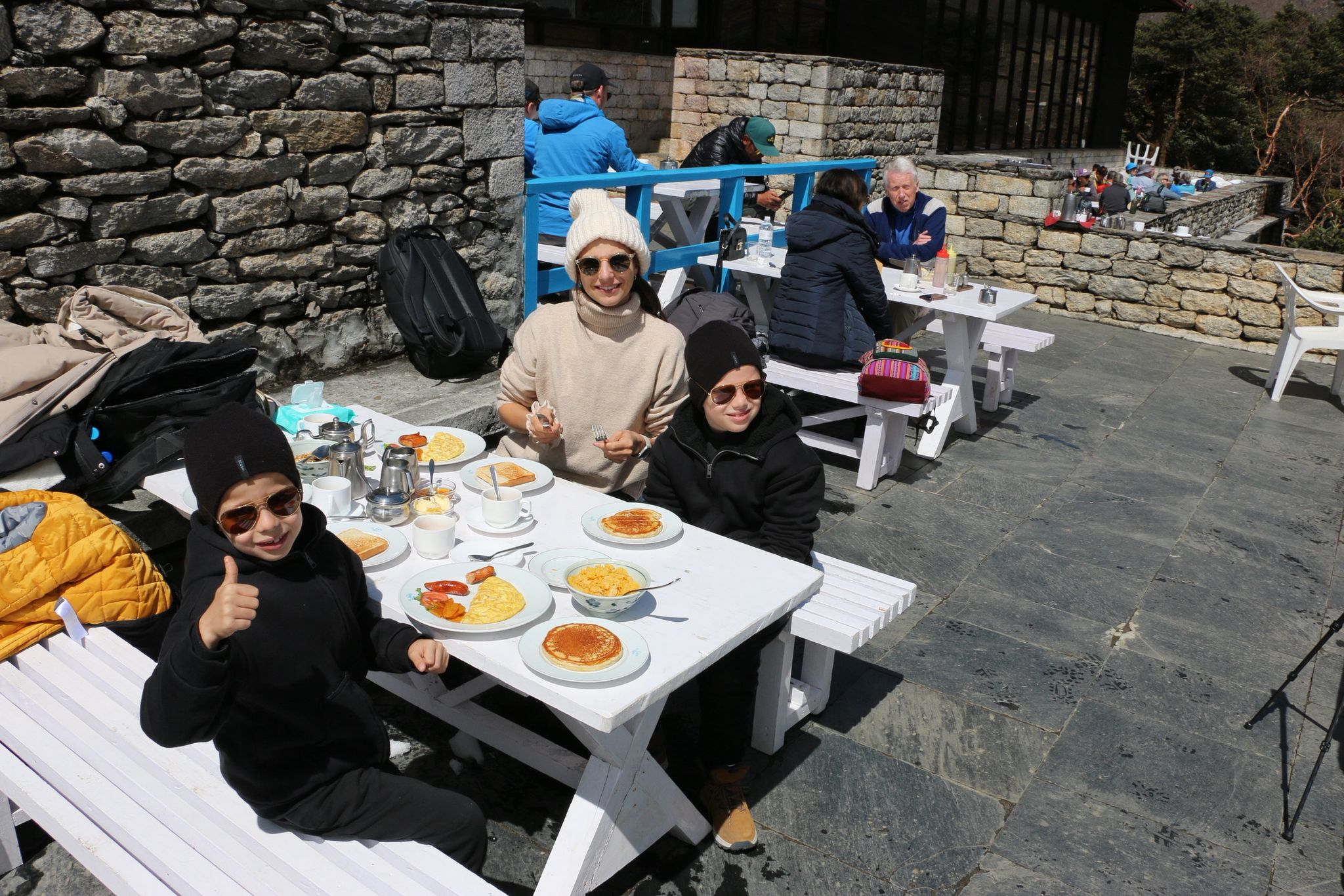 Family with young Kids enjoying breakfast with a stunning view at Everest View Hotel during the Mount Everest Helicopter Tour.