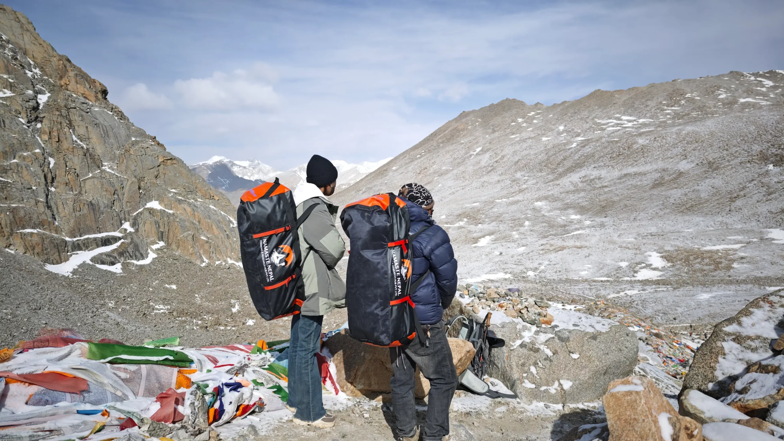 Porter carrying backpack on the way to Dolma-La Pass during Mount Kailash Kora.