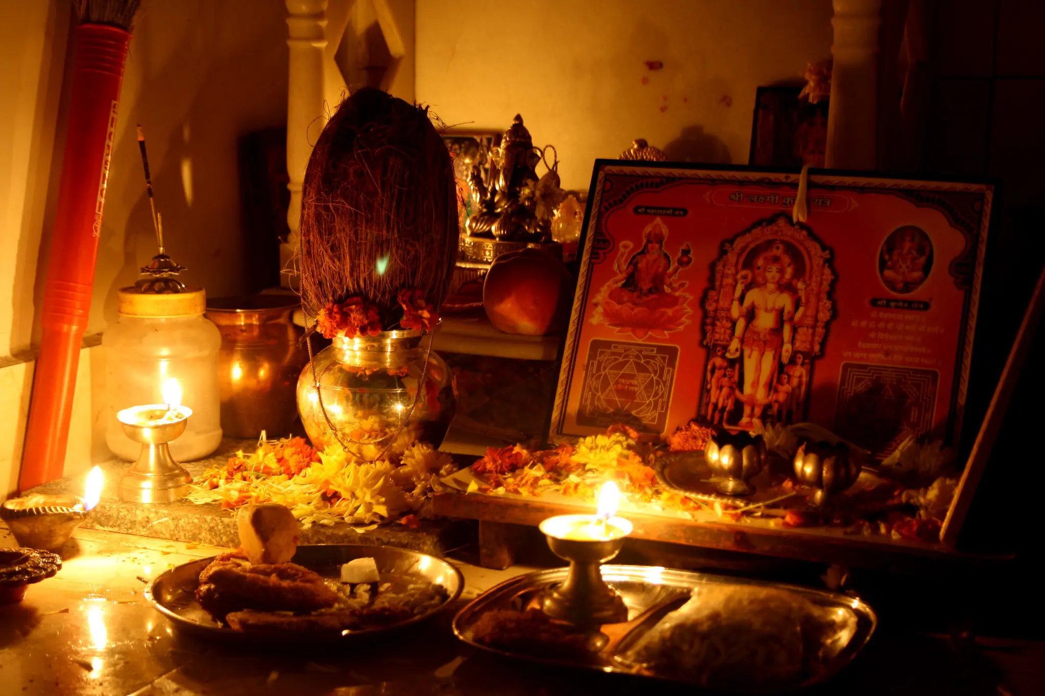 Laxmi Puja celebration with traditional rituals and oil lamps.