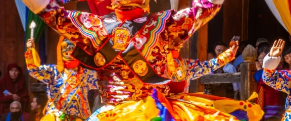 Traditional Bhutanese cultural dance performance showcasing vibrant costumes and masked dancers.