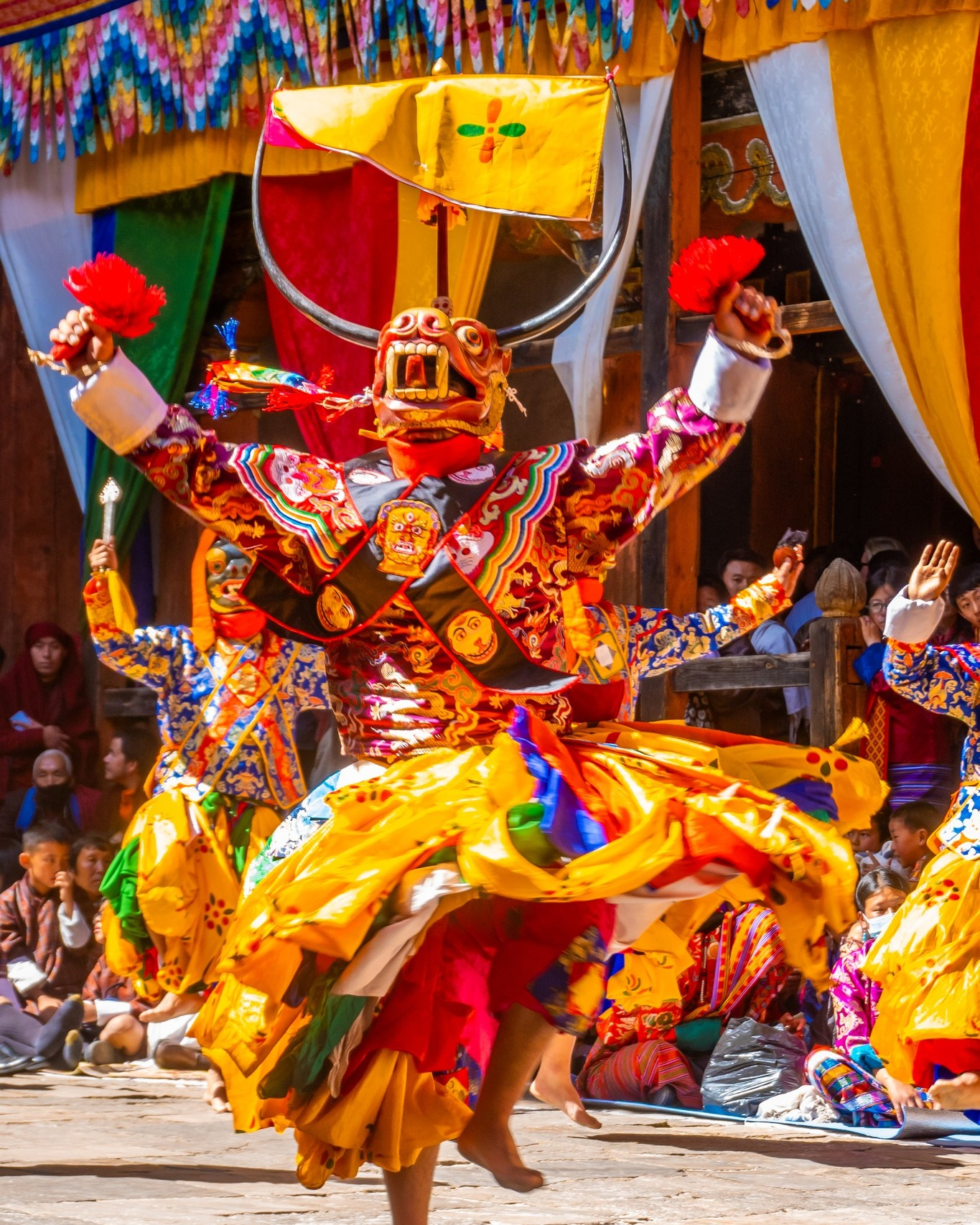 Traditional Bhutanese cultural dance performance showcasing vibrant costumes and masked dancers.