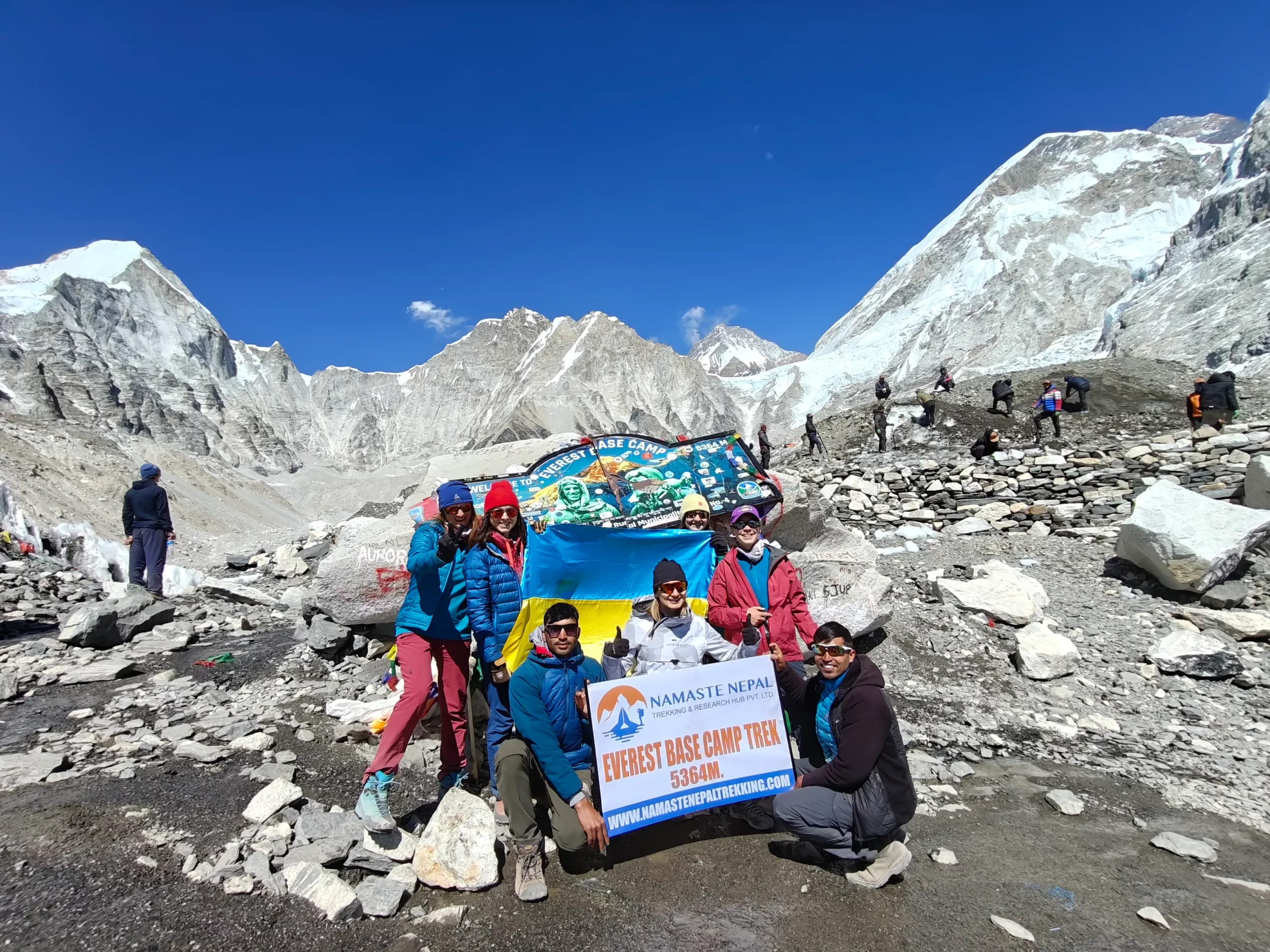 Team Namaste Nepal standing at iconic Everest Base Camp during premium trek