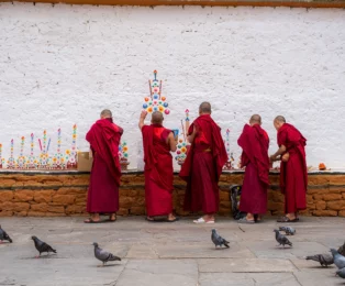Young monks painting at a monastery in Thimphu – cultural and spiritual moment in Bhutan.