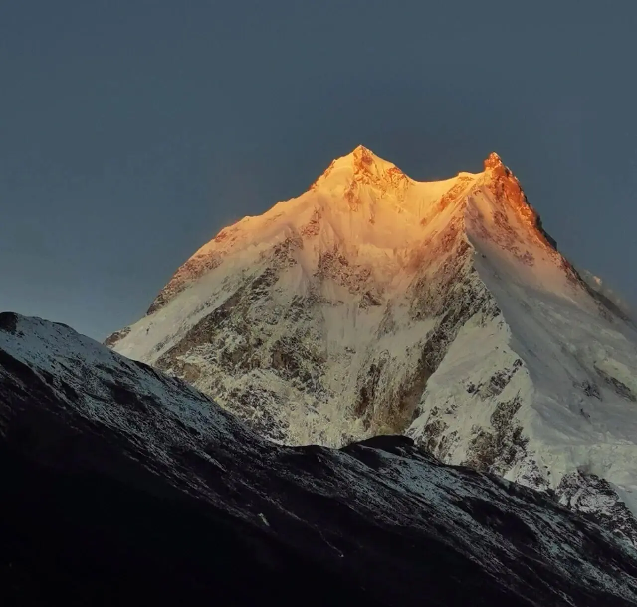 Golden glow on Mount Manaslu during sunrise on the Manaslu Circuit Trek.