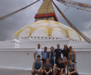 Kamal Dhodari with a Group at Boudhanath Stupa during cultural tour.