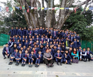 Kamal Dhodari teaching and guiding high school students in Nepal tourism education.