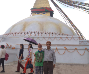 Kamal Dhodari with a young tourist at Boudhanath Stupa during cultural tour.