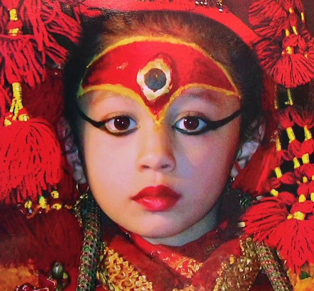 Living Goddess Kumari of Nepal in traditional red attire and ceremonial makeup during a cultural festival in Kathmandu
