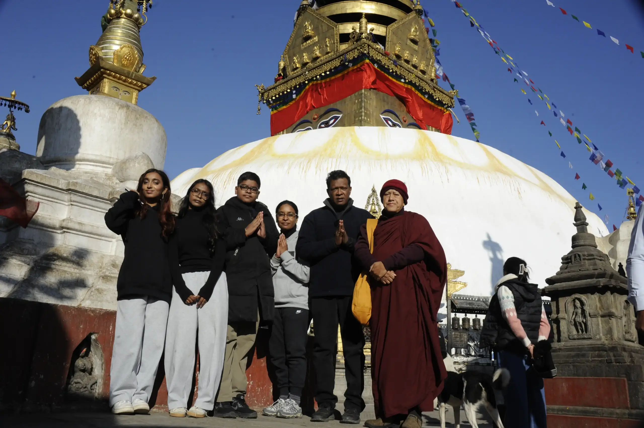 Family group visiting the sacred Swayambhunath Stupa in Kathmandu during a family tour in Nepal
