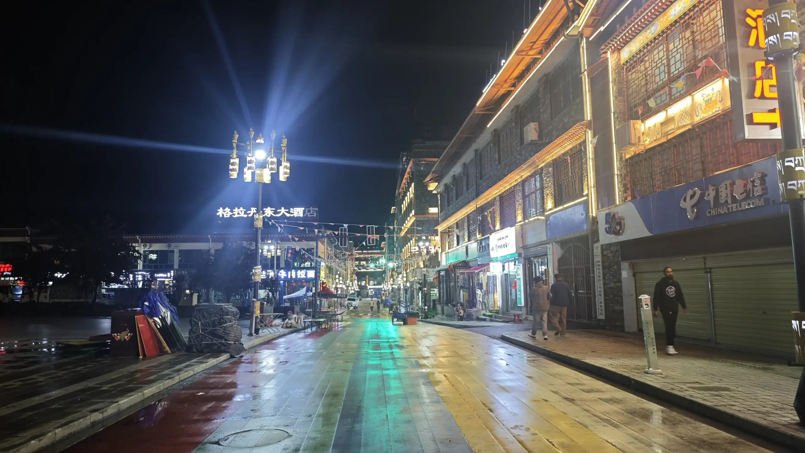Colorful Tibetan town street illuminated at night during Kailash Mansarovar pilgrimage journey