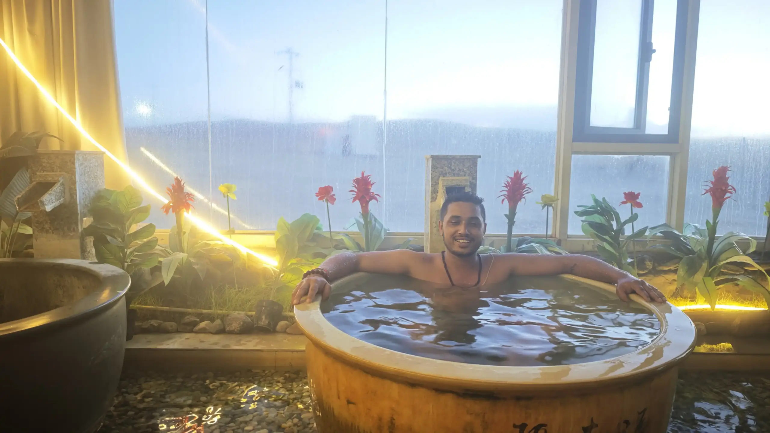 Pilgrim relaxing in a hot spring tub during the Kailash Mansarovar Yatra near Lake Mansarovar in Tibet