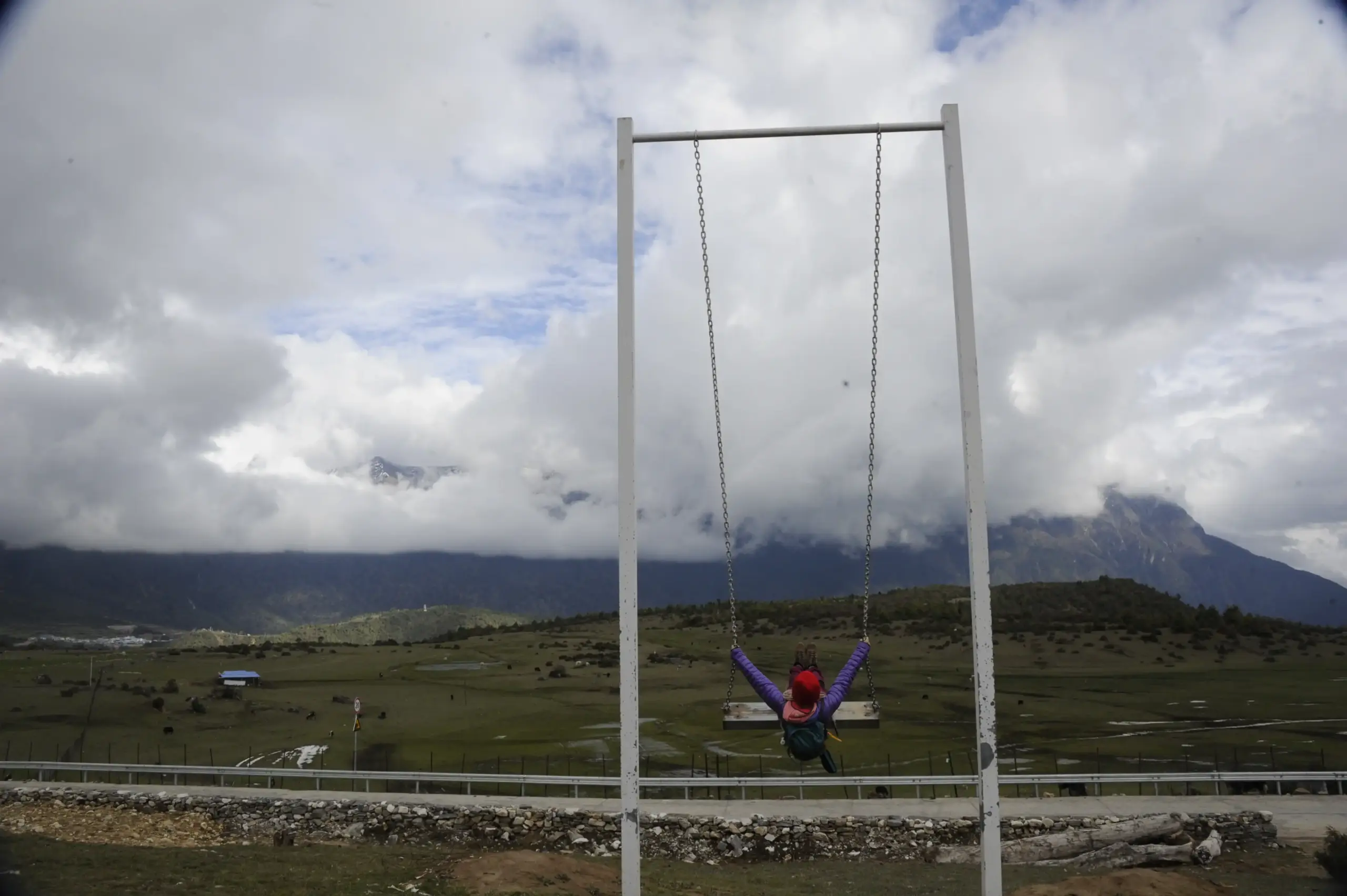 Pilgrim enjoying a giant swing with Himalayan mountain views during Kailash Mansarovar Yatra 2026