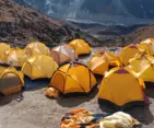 A vibrant tented camp nestled among the mountains, serving as a key stop on the journey to Mera Peak.