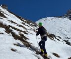 Climber standing on the snowy slopes of Mera Peak with panoramic Himalayan mountain views in Nepal