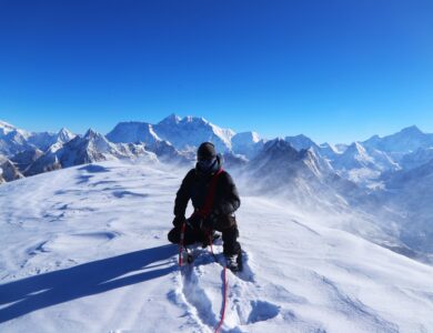 Our experienced guide on the summit of Mera Peak with Mount Everest and surrounding peaks.