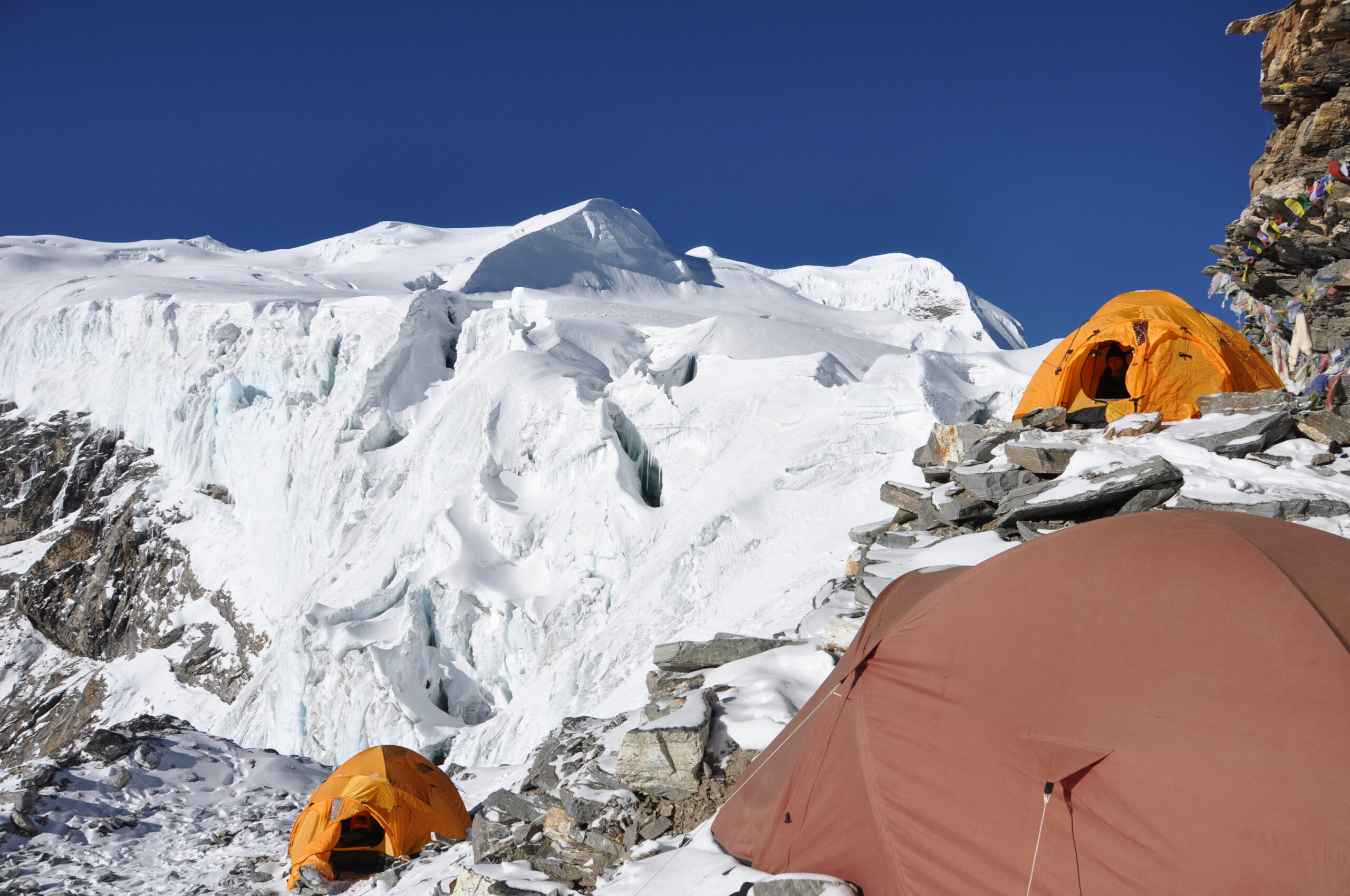 Mera Peak High Camp tents overlooking snow-covered Himalayan mountains during a climbing expedition in Nepal