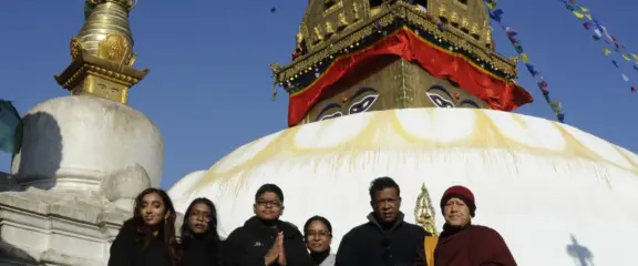 Our guests meeting a Buddhist monk for a special Puja at Swayambhunath Mahachaitya during the Best of Nepal Tour.