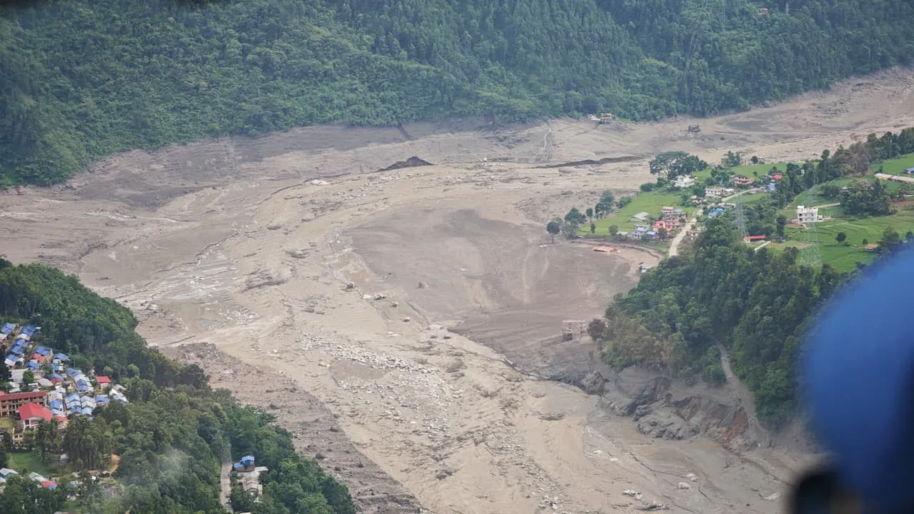 Aerial view of extensive flood and landslide damage caused by the 2026 Langtang Lirung Avalanche and Bhotekoshi flood, with debris covering the valley near residential areas.